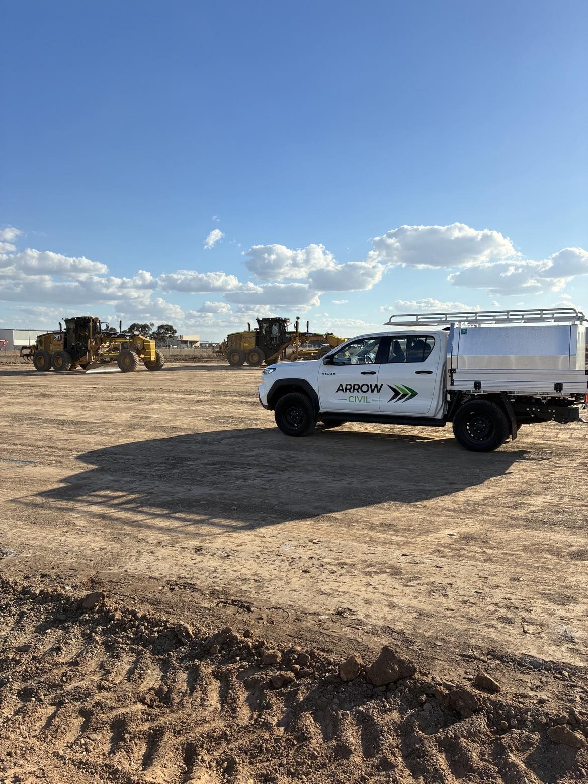 Large scale bulk earthworks building pad with graders and Arrow Civil ute on site