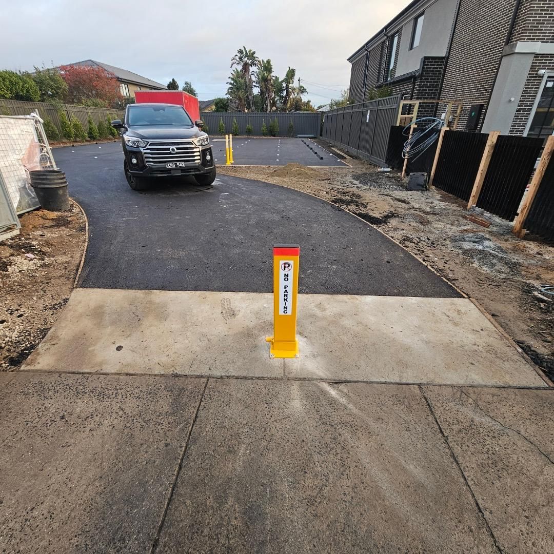Completed commercial carpark with new asphalt, concrete crossover and No Parking bollard, Glen Waverley